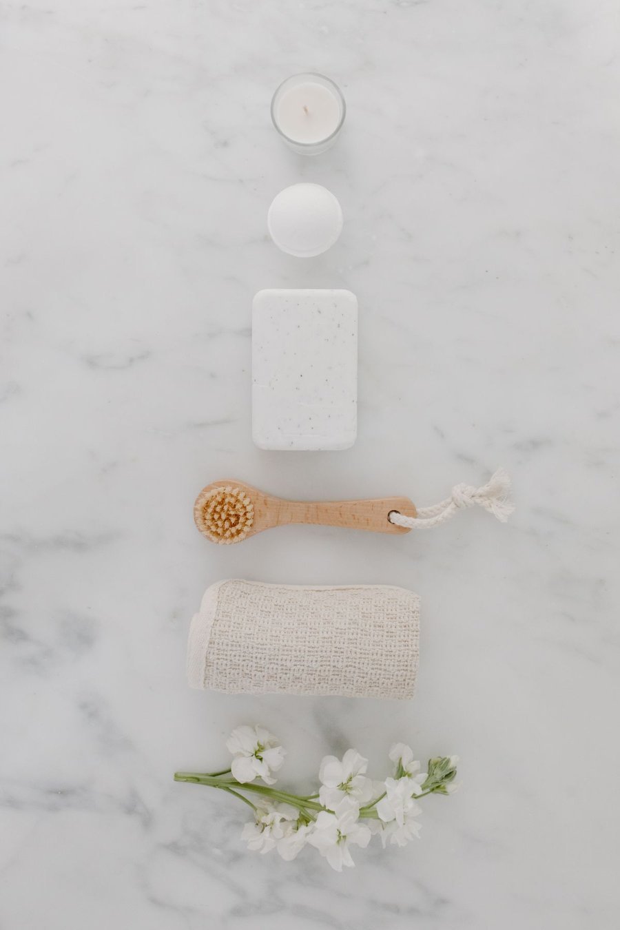 Livora Dream Bath & Body spa essentials flatlay - candle, soap, and natural bath accessories